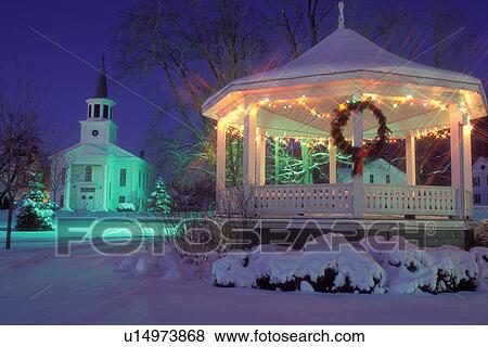 Stock Photo -  Vermont, Christmas, The decorations on the snow covered church and gazebo on the Green are illuminated at [night, evening] for the Christmas Holidays in Bristol.. Fotosearch