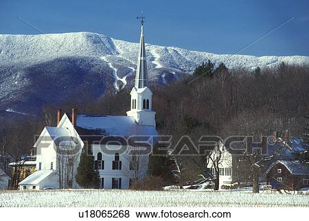Stock Photo -  Vermont, church, Mad River Valley, Scenic New England village of Waitsfield and the Federated Church in the winter. Snow covers the Green Mountains and Sugarbush Ski Area in the background.. Fotosearch