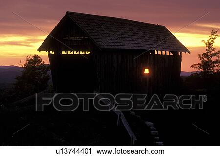 Stock Image -  Vermont, covered bridge, A silhouette of Foster Covered Bridge at [sunrise, sunset] in Cabot.. Fotosearch