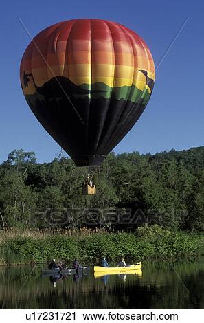 Vermont, hot air balloon, canoe, canoeing, A colorful Jurassic Park hot air balloon hovers above canoes on a pond in Quechee. Quechee Hot Air Balloon Festival. View Large Photo Image Stock Image - Vermont, hot air balloon, canoe, canoeing, A colorful Jurassic Park hot air balloon hovers above canoes on a pond in Quechee. Quechee Hot Air Balloon Festival.. Fotosearch