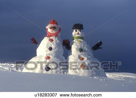 Vermont, snowmen, Mr & Mrs Snowman hold hands together up on a snow covered hill in Montpelier View Large Photo Image Stock Photo - Vermont, snowmen, Mr & Mrs Snowman hold hands together up on a snow covered hill in Montpelier . Fotosearch