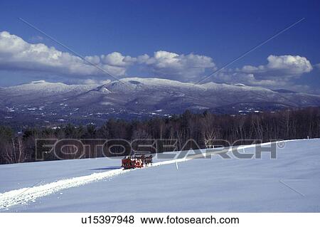 Vermont, Stowe, A sleigh ride in a snowy field with a scenic view of the Worcester Mountain Range from Trapp Family Lodge in Stowe., View Large Photo Image Stock Photo - Vermont, Stowe, A sleigh ride in a snowy field with a scenic view of the Worcester Mountain Range from Trapp Family Lodge in Stowe., . Fotosearch