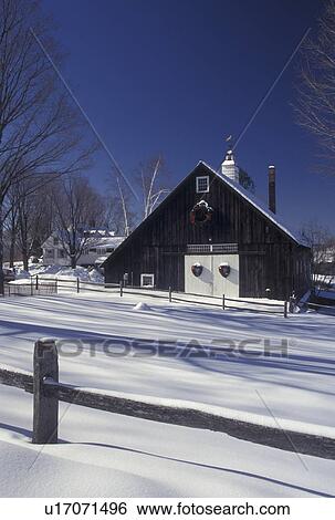 Stock Photograph -  Vermont, VT, Brown barn with white doors decorated with wreaths in the snow in winter in Pomfret . Fotosearch