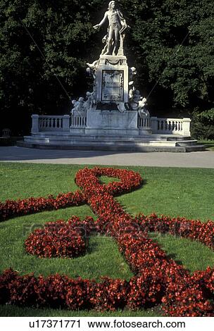 Vienna, Mozart, Austria, Europe, A red floral G clef decorates the lawn in front of the Mozart Memorial Statue (Wolfgang Amadeus Mozart) in Burggarten in downtown Vienna. View Large Photo Image Stock Image - Vienna, Mozart, Austria, Europe, A red floral G clef decorates the lawn in front of the Mozart Memorial Statue (Wolfgang Amadeus Mozart) in Burggarten in downtown Vienna.. Fotosearch