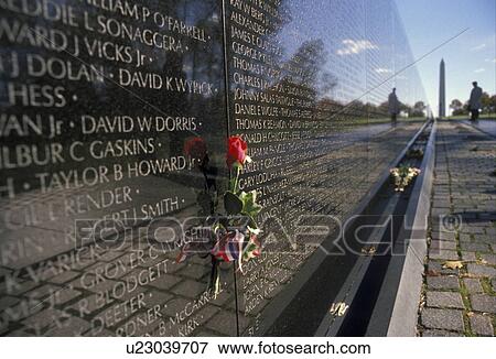 Washington, DC, Vietnam Veterans Memorial Wall, District of Columbia, Red rose placed next to loved one who died in the Vietnam war on the V-shaped black granite wall of the Vietnam Veterans Memorial in Washington, D. C. View Large Photo Image Stock Photo - Washington, DC, Vietnam Veterans Memorial Wall, District of Columbia, Red rose placed next to loved one who died in the Vietnam war on the V-shaped black granite wall of the Vietnam Veterans Memorial in Washington, D. C.. Fotosearch