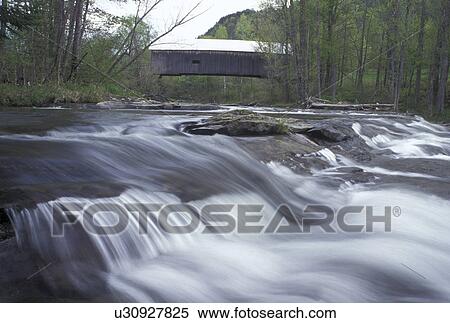 Stock Photography -  waterfall, covered bridge, river, Vermont, VT, The Flint Covered Bridge, ca. 1845, crosses over the First Branch White River in Tunbridge in the spring. . Fotosearch