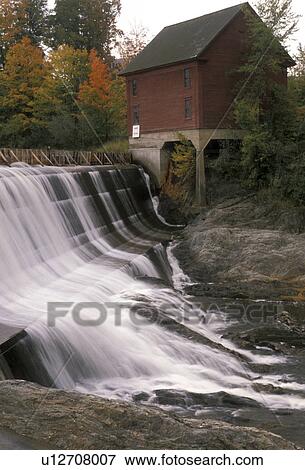 waterfall, dam, Vermont, Morrisville, Lamoille River, Scenic waterfall running over a dam next to a red wooden house in the fall. View Large Photo Image Stock Photo - waterfall, dam, Vermont, Morrisville, Lamoille River, Scenic waterfall running over a dam next to a red wooden house in the fall.. Fotosearch