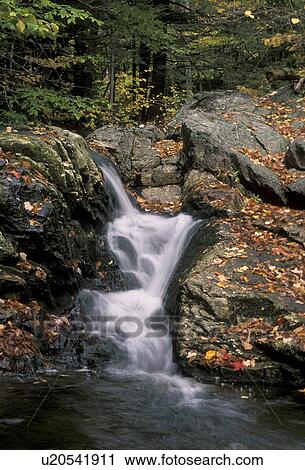 Stock Image -  waterfall, fall, river, Maine, White Mountain National Forest, Waterfall flows down over the rocks into the river in the fall.. Fotosearch