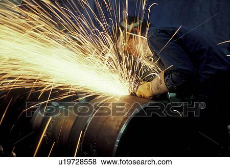 Stock Photo -  welding, Bright yellow sparks fly as a welder is grinding a steam valve.. Fotosearch