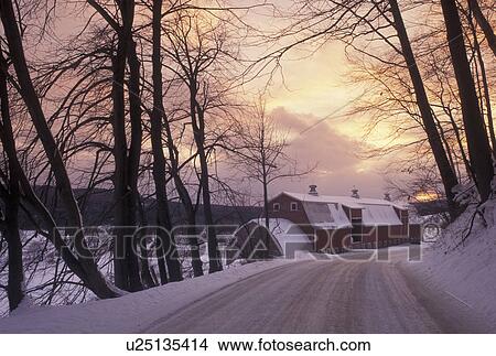 winter scene, sunset, country road, Vermont, Snow covered country road curves around in front of a red barn at sunset on a winter day in Cambridge in Lamoille County in the state of Vermont. View Large Photo Image Picture - winter scene, sunset, country road, Vermont, Snow covered country road curves around in front of a red barn at sunset on a winter day in Cambridge in Lamoille County in the state of Vermont. . Fotosearch