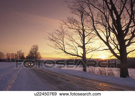 winter, Vermont, VT, Car driving down snow-covered country road at sunset in winter in East Montpelier. View Large Photo Image Stock Photo - winter, Vermont, VT, Car driving down snow-covered country road at sunset in winter in East Montpelier.. Fotosearch