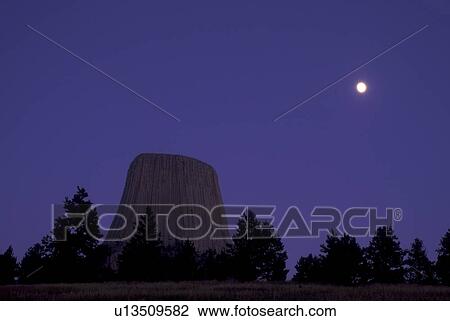 Wyoming, Full moon rises over Devils Tower National Monument at night. View Large Photo Image Stock Image - Wyoming, Full moon rises over Devils Tower National Monument at night.. Fotosearch