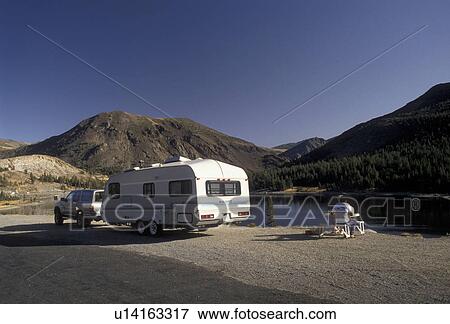 Yosemite, Yosemite National Park, Tioga Pass, camper, trailer, Sierra Nevada Mountains, California, Couple eating at picnic table on a pull over on Tioga Lake at Tioga Pass near Yosemite Nat'l Park in the state of California. View Large Photo Image Stock Photo -  Yosemite, Yosemite National Park, Tioga Pass, camper, trailer, Sierra Nevada Mountains, California, Couple eating at picnic table on a pull over on Tioga Lake at Tioga Pass near Yosemite Nat'l Park in the state of California.. Fotosearch