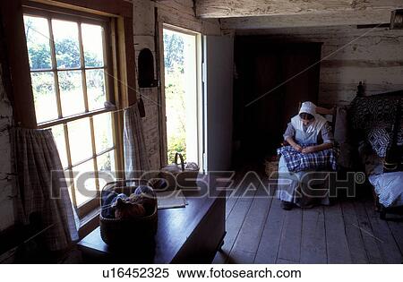 Stock Photography -  Abraham Lincoln, Lerna, IL, Illinois, Interpreter sits inside the Lincoln Cabin making a quilt at Lincoln Log Cabin State Historic Site.. Fotosearch