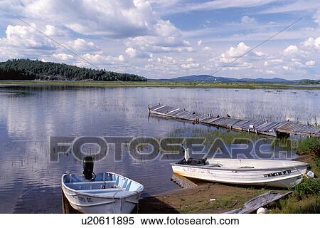 Stock Photography -  Adirondacks, New York, NY, Moody, Boats on the beach and old dock in the water on Tupper Lake in Adirondack Park.. Fotosearch