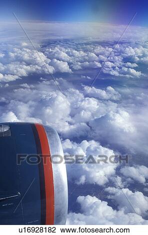 Stock Image -  aerial, airplane, clouds, American West Airlines flying over the Southern Rockies.. Fotosearch