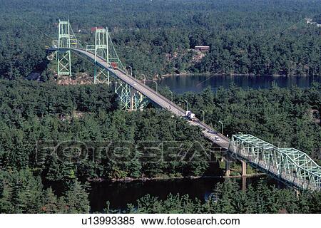 aerial, bridge, Thousand Islands, NY, International Bridge, Alexandria Bay, New York, St. Lawrence River, Aerial view of the Thousand Islands and International Bridge crossing the St. Lawrence River into Ontario, Canada from the Thousand Islands Skydeck. View Large Photo Image Stock Photography - aerial, bridge, Thousand Islands, NY, International Bridge, Alexandria Bay, New York, St. Lawrence River, Aerial view of the Thousand Islands and International Bridge crossing the St. Lawrence River into Ontario, Canada from the Thousand Islands Skydeck.. Fotosearch