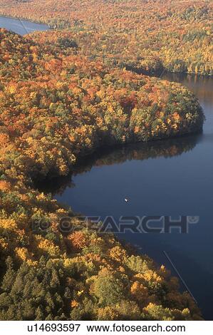 Stock Photo -  aerial, lake, fall, Woodbury, VT, Vermont, Scenic aerial view from Nichols Ledge of the colorful fall foliage surrounding Nichols Pond in the autumn.. Fotosearch