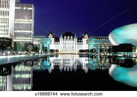 Picture -  Albany, State Capitol, capitol, Statehouse, New York, Reflection of the State Capitol Building in the pool at the Governor Nelson A. Rockefeller Empire State Plaza illuminated at night in Albany, New York. . Fotosearch