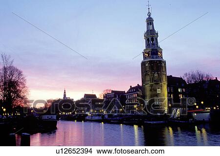 Amsterdam, canal, The Netherlands, Holland, Europe, Scenic view of a canal (grachten) and clock tower at sunset in downtown Amsterdam. View Large Photo Image Picture - Amsterdam, canal, The Netherlands, Holland, Europe, Scenic view of a canal (grachten) and clock tower at sunset in downtown Amsterdam. . Fotosearch