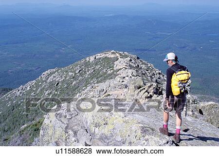 Stock Photo -  Appalachian Trail, hiking, Mt. Katahdin, Baxter Park, Maine, ME, Man hiking the rugged Hunt Trail part of the Appalachian Trail on Mt. Katahdin in Baxter State Park. . Fotosearch