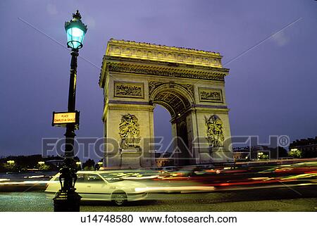Arc de Triomphe, Paris, France, Europe, Arc de Triomphe at Place Charles de Gaulle illuminated at night in Paris. Traffic passing around the circle. View Large Photo Image Stock Image - Arc de Triomphe, Paris, France, Europe, Arc de Triomphe at Place Charles de Gaulle illuminated at night in Paris. Traffic passing around the circle.. Fotosearch