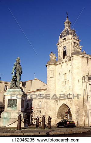 Stock Photography -  arch, France, La Rochelle, Poitou-Charentes, Charente-Maritime, Europe, Tour de la grosse horloge at the ancient fortified port city of La Rochelle on the Atlantic Ocean.. Fotosearch