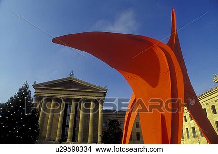 Picture -  art museum, Philadelphia, Pennsylvania, PA, Red Calder sculpture and Christmas tree outside the Philadelphia Museum of Art in downtown Philadelphia.. Fotosearch
