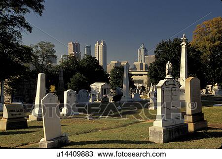 Stock Image -  Atlanta, Georgia, GA, Historic Oakland Cemetery, and view of the skyline of Atlanta.. Fotosearch