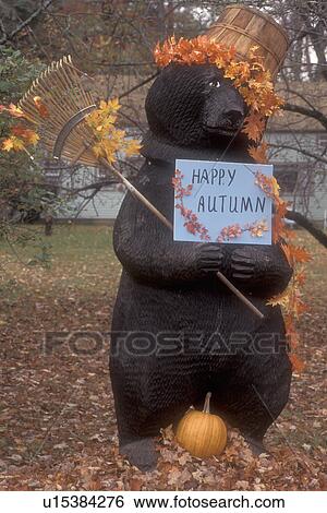 autumn, fall decoration, bear, Large wooden bear sculpture displays a Happy Autumn sign dressed with basket of colorful maple leaves on his head and rake in hand for fall display in Arlington in Bennington County in the state of Vermont. View Large Photo Image Stock Photograph - autumn, fall decoration, bear, Large wooden bear sculpture displays a Happy Autumn sign dressed with basket of colorful maple leaves on his head and rake in hand for fall display in Arlington in Bennington County in the state of Vermont.. Fotosearch