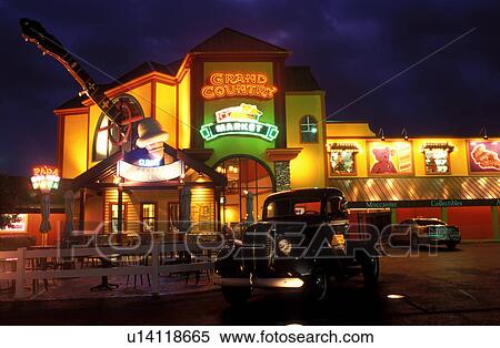 Stock Photography -  banjo, Branson, country music, MO, Missouri, World's Largest Banjo displayed at the Grand Country Square in Branson in the evening and antique truck.. Fotosearch