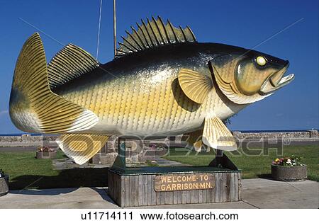 Stock Image -  Bass, fish, welcome sign, Garrison, MN, Minnesota, Giant statue of a Bass (fish). Welcome to Garrison.. Fotosearch