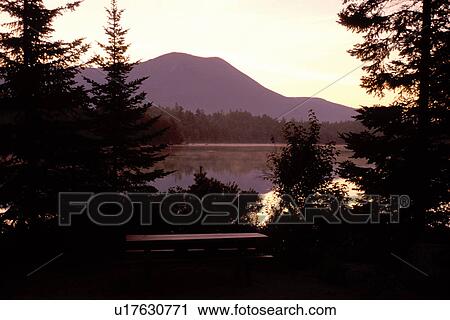 Stock Image -  Baxter Park, Maine, ME, sunset, sunrise, Scenic view of Mt. Katahdin reflecting in the calm waters of Daicey Pond at sunrise in Baxter State Park.. Fotosearch