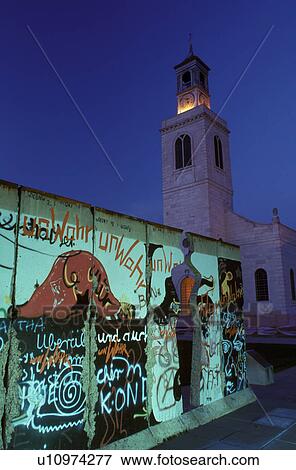 Stock Photo -  Berlin Wall, Winston Churchill, college, Fulton, MO, Missouri, Part of the Berlin Wall outside the Winston Churchill Memorial and Library at the Church of Saint Mary the Virgin, Aldermanbury in the evening on Westminster College campus.. Fotosearch