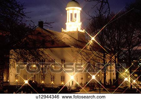 Stock Photograph -  Bethlehem, church, Pennsylvania, PA, Candles illuminate the windows of the Moravian Church at night for the Christmas holiday in Bethlehem. . Fotosearch