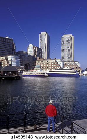 Boston, Massachusetts, MA, Man with a red jacket looking out over Boston Inner Harbor at the skyline of downtown Boston. View Large Photo Image Stock Image - Boston, Massachusetts, MA, Man with a red jacket looking out over Boston Inner Harbor at the skyline of downtown Boston.. Fotosearch