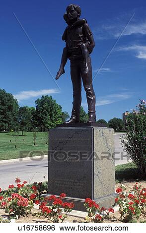 Stock Photograph -  Boys Town, Omaha, NE, Nebraska, Statue of an older boy carrying a small boy at Boys Town founded by Father Flanagan.. Fotosearch