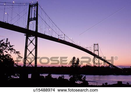 bridge, International Bridge, Thousand Islands, Alexandria Bay, New York, St. Lawrence River, NY, International Bridge at sunset crosses the St. Lawrence River into Ontario, Canada. View Large Photo Image Picture - bridge, International Bridge, Thousand Islands, Alexandria Bay, New York, St. Lawrence River, NY, International Bridge at sunset crosses the St. Lawrence River into Ontario, Canada.. Fotosearch