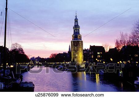 canal, Amsterdam, Holland, The Netherlands, Europe, Scenic view of a canal (grachten) and clock tower at sunset in downtown Amsterdam. View Large Photo Image Stock Photo - canal, Amsterdam, Holland, The Netherlands, Europe, Scenic view of a canal (grachten) and clock tower at sunset in downtown Amsterdam. . Fotosearch