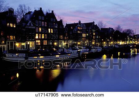 canal, Amsterdam, Holland, The Netherlands, Europe, Houses reflect in the calm waters of the canal (grachten) in downtown Amsterdam at night View Large Photo Image Stock Photography - canal, Amsterdam, Holland, The Netherlands, Europe, Houses reflect in the calm waters of the canal (grachten) in downtown Amsterdam at night . Fotosearch