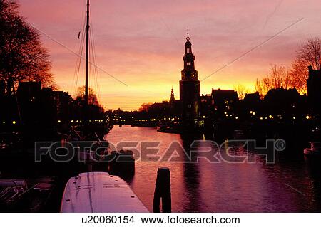 Picture -  canal, Amsterdam, The Netherlands, Holland, Europe, Scenic view of a canal (grachten) at sunset in downtown Amsterdam. . Fotosearch