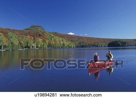 canoe, canoeing, Vermont, VT, Mother and daughter paddle a red canoe on Long Pond in Westmore in the fall. View Large Photo Image Stock Image - canoe, canoeing, Vermont, VT, Mother and daughter paddle a red canoe on Long Pond in Westmore in the fall. . Fotosearch