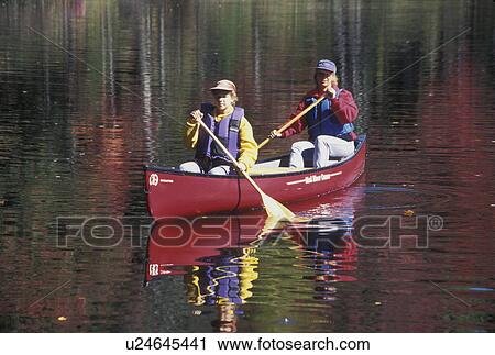 canoe, canoeing, Vermont, VT, Mother and daughter paddle a red canoe on Green River Reservoir in Hyde Park in the fall. View Large Photo Image Stock Image - canoe, canoeing, Vermont, VT, Mother and daughter paddle a red canoe on Green River Reservoir in Hyde Park in the fall. . Fotosearch