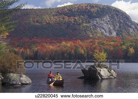 canoeing, autumn, Vermont, VT, Mother and daughter paddle a red canoe on scenic Marshfield Pond surrounded by colorful foliage in the fall. View Large Photo Image Stock Photography - canoeing, autumn, Vermont, VT, Mother and daughter paddle a red canoe on scenic Marshfield Pond surrounded by colorful foliage in the fall. . Fotosearch