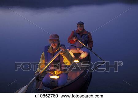 canoeing, canoe, Vermont, VT, Candles reflect on a mother and daughter in a red canoe in the evening on Island Pond. View Large Photo Image Stock Image - canoeing, canoe, Vermont, VT, Candles reflect on a mother and daughter in a red canoe in the evening on Island Pond. . Fotosearch