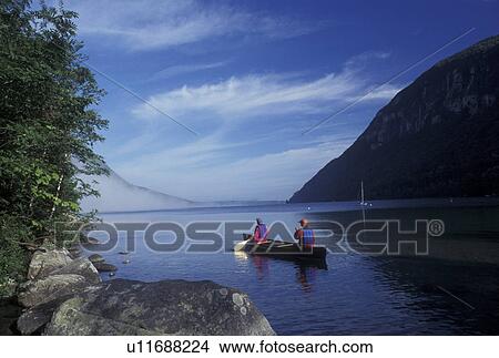 Picture -  canoeing, canoe, Vermont, VT, Mother and daughter paddling a red canoe in the fog on Lake Willoughby in Westmore. Fotosearch