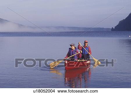 canoeing, canoe, Vermont, VT, Mother and daughter paddling a red canoe in the fog on Lake Willoughby in Westmore View Large Photo Image Picture - canoeing, canoe, Vermont, VT, Mother and daughter paddling a red canoe in the fog on Lake Willoughby in Westmore. Fotosearch
