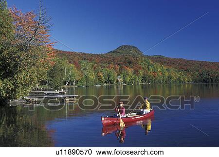 canoeing, canoe, Vermont, VT, Mother and daughter paddling a red canoe on Long Pond in Westmore in the fall. View Large Photo Image Stock Image - canoeing, canoe, Vermont, VT, Mother and daughter paddling a red canoe on Long Pond in Westmore in the fall. . Fotosearch