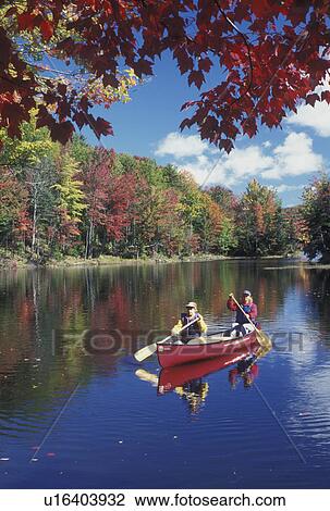 canoeing, canoe, Vermont, VT, Mother and daughter paddling a red canoe on Green River Reservoir in Hyde Park in the fall. View Large Photo Image Stock Image - canoeing, canoe, Vermont, VT, Mother and daughter paddling a red canoe on Green River Reservoir in Hyde Park in the fall. . Fotosearch