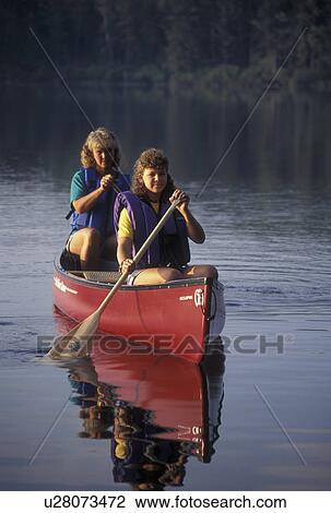 canoeing, canoe, Vermont, VT, Mother and daughter paddling a red canoe on Kettle Pond in Groton State Forest. View Large Photo Image Stock Image - canoeing, canoe, Vermont, VT, Mother and daughter paddling a red canoe on Kettle Pond in Groton State Forest.. Fotosearch